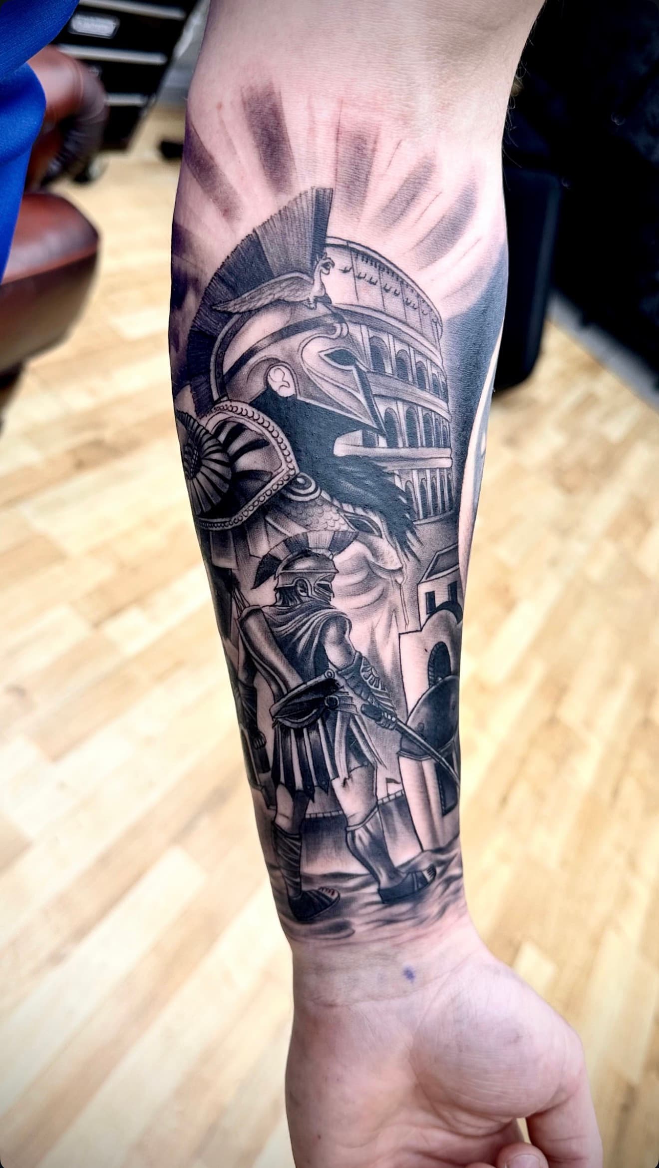 Black and grey Roman gladiator and Colosseum forearm tattoo by Cioffi Tattoo