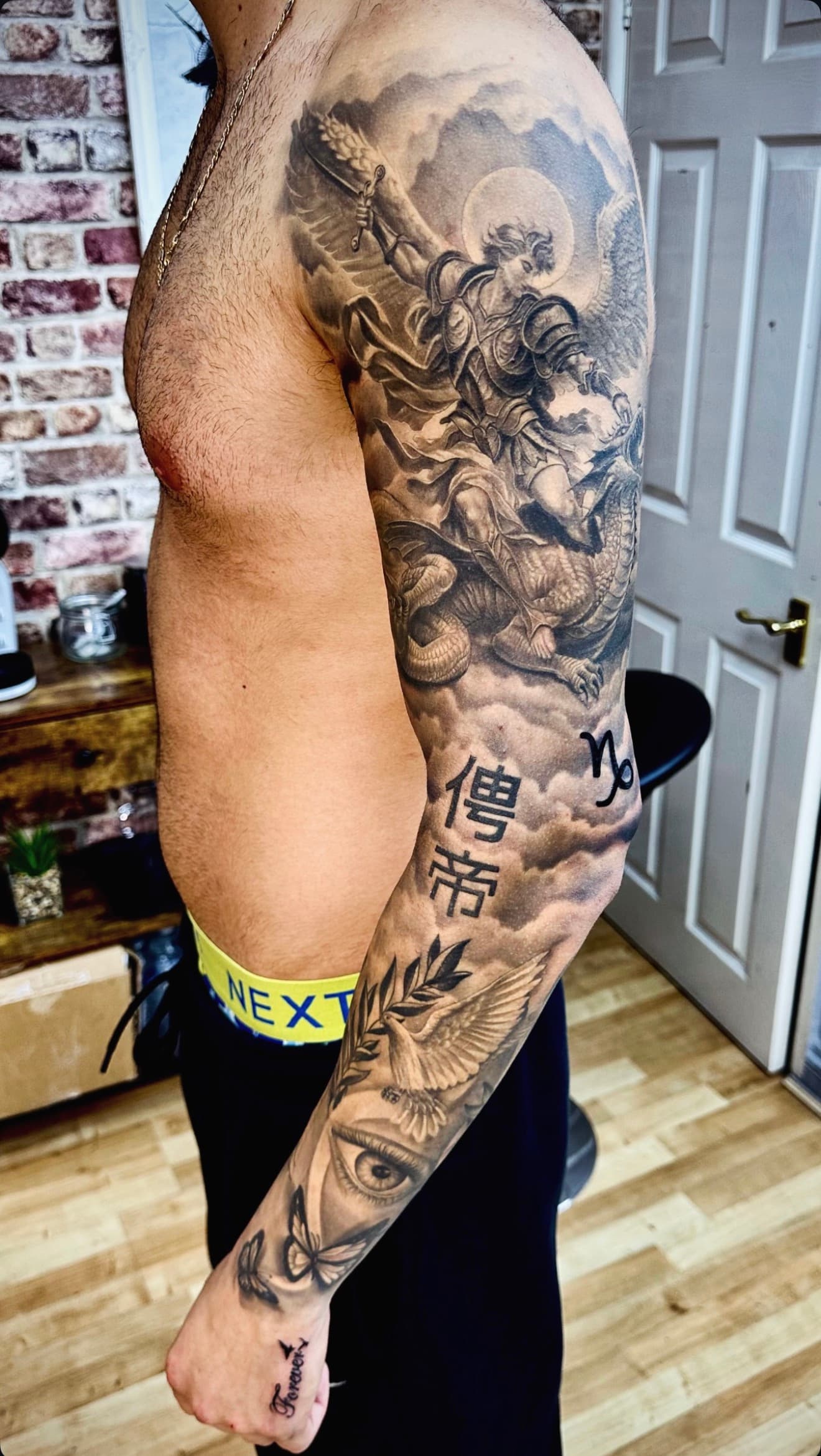 Black and grey archangel and dragon sleeve tattoo by Cioffi Tattoo